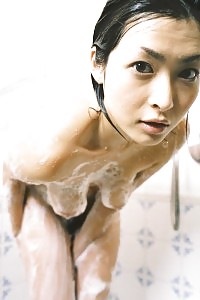 Asian Bitch In A Dress Is Jerking Off And Pinching Her Hard Tits In Her Bed