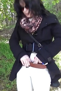 Black Haired Model In Sunglasses Pisses Outside